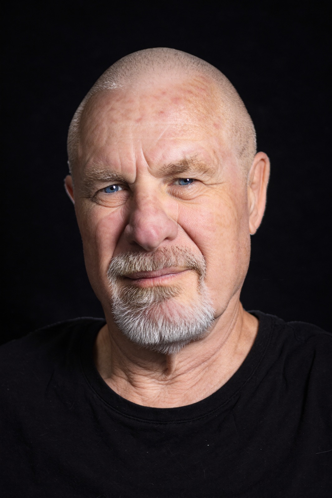 Vishrant, studio portrait on black, direct to camera.