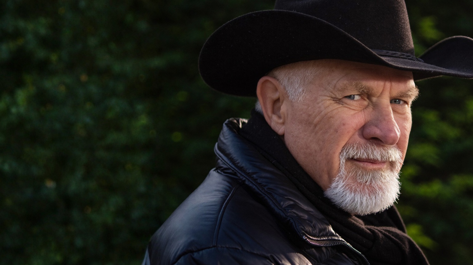 Vishrant in a black hat, looking over his shoulder at the camera