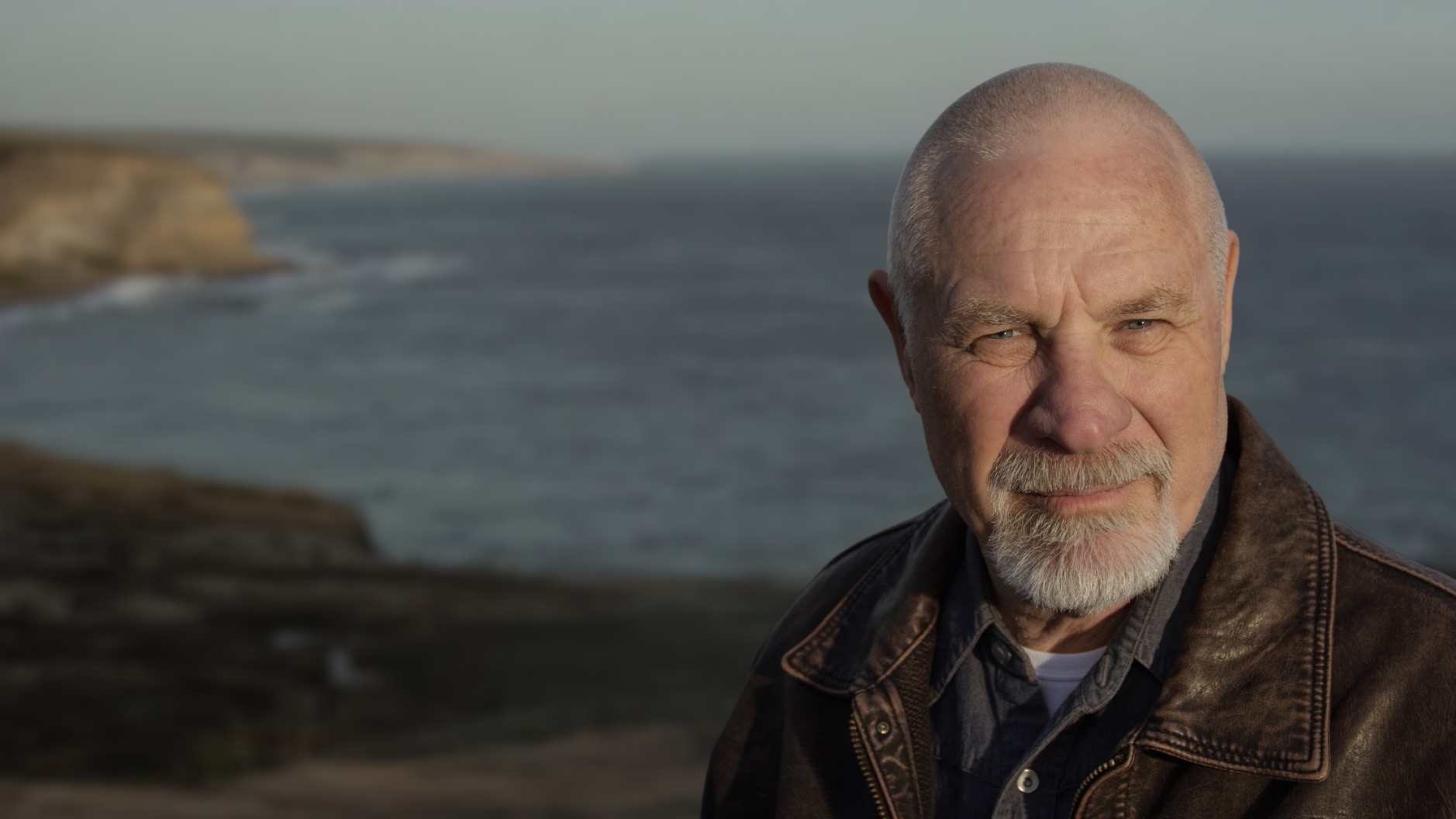 Vishrant on the Western Australian coast, ocean and cliffs behind him