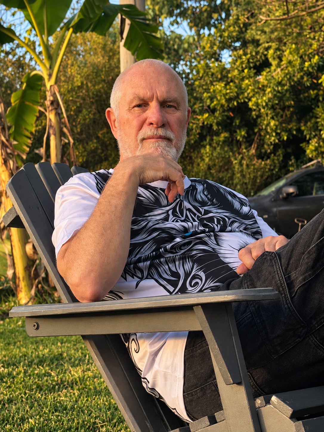 Vishrant sitting in a garden chair, looking at the camera